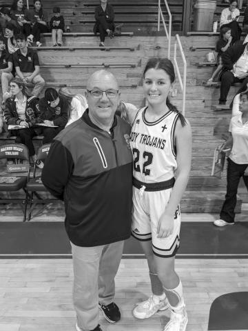 Kali Shiver (right) is pictured with her head coach Craig Whittington (left) after collecting the 1 thousandth point of her career as a Sacred Heart Lady Trojan. (Gazette photo by Rhett Manuel)