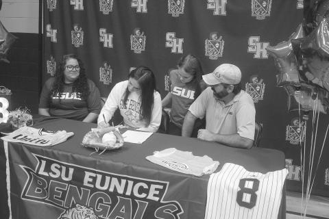 Amelia Fontenot (center), of Sacred Heart High School, is pictured as she signs to play softball at LSU-E. Pictured on the left is her mother, Rebecca, and on the right is her father, Lance. Also pictured is her sister, Eloise. (Gazette photo by Tony Marks)