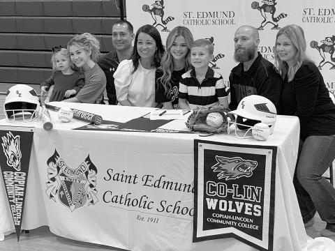 Flanked by her family and head coach Nick Trosclair, Vidrine native Karleigh Soileau signs a National Letter of Intent to play softball for Copiah-Lincoln Community College. (Gazette photo by Rhett Manuel)