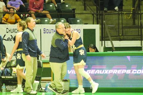 Sacred Heart girls’ basketball head coach Craig Whittington (left) consoles senior player Kali Shiver (right) as she exits the state semifinal game against Southern Lab. (Gazette photo by Tony Marks)