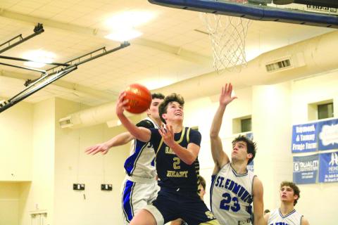 Sacred Heart guard Ellis Chapman goes up for a layup in last Friday’s 60-44 win over St. Edmund. The Trojan boys and girls split their games with the Blue Jays in District 5-1A play. (LSN Photo by Rhett Manuel)