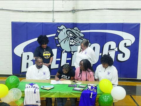 Destiny Lavigne (seated center left) is pictured as she signs to play college softball with Xavier University of Louisiana. Also pictured (from left) are standing Ville Platte High School Principal Shelsy Williams and former Ville Platte High School Assistant Principal Dawn Bellard; seated- Ville Platte High School Softball Coach Devinskie Arvie, Latoya Lavigne, and Ville Platte High School Assistant Coach Shonda Jack. (File photo)