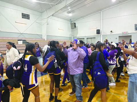 Ville Platte Mayor Ryan LeDay Williams (center) greets Donashia Jack (14) on the court after the 5th seed Ville Platte Lady Bulldogs pulled off an upset against 4th seed Springfield in the quarterfinals. With the win, Ville Platte advanced to the girls’ basketball state semifinals. (Gazette photo by Tony Marks)