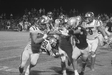 Drew Mayeaux (28) tries to force a St. Edmund ball carrier out of bounds in Sacred Heart’s 58-36 home loss last Friday. (Gazette photo by Tony Marks)