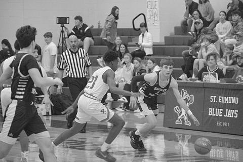 Elliot Fontenot (1) drives down the court past a Lacassine defender in Sacred Heart’s 74-48 loss in the finals of the Kendall and Brad Fontenot Memorial Shootout. (LSN photo by Rhett Manuel)