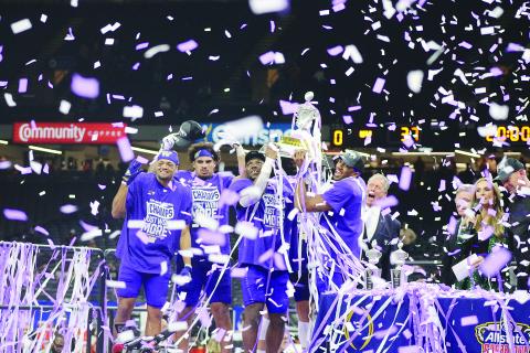 Offensive MVP Michael Penix Jr. along with Defensive MVP Bralen Trice and other members of the Washington Huskies hoist the Allstate Sugar Bowl Trophy after a 37-31 win over the Texas Longhorns. (Gazette photo by Tony Marks)