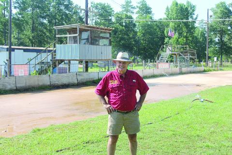 Richard Loveless is pictured as the new sprinkler system waters down the track at Turkey Creek. He is leasing the track from the village on a yearly basis with hopes of expansion. (Gazette photo by Tony Marks)