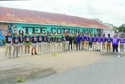 From left are Trojan seniors, Campbell Earles, Everett Johnson, Hayden Droddy, Tucker Chesne, Collin Estilette, Max Hamlin, Briggs Ardoin, Bradley Fusilier, Gabe Wilmouth, Blake Hebert, and Gabe Fontenot; assistant coaches, Daniel Scully and JP Boullion; head coach, Josh Harper; and Bulldog head coach Roy Serie; and seniors, Christian Aclis, Bastian Veillon, Charles Jason, Jakahalan Slaughter, Omarion Frank, Adonis Thomas, Troas Murray, Austin Fontenot, and Allyus Dick. (Gazette photo by Tony Marks)