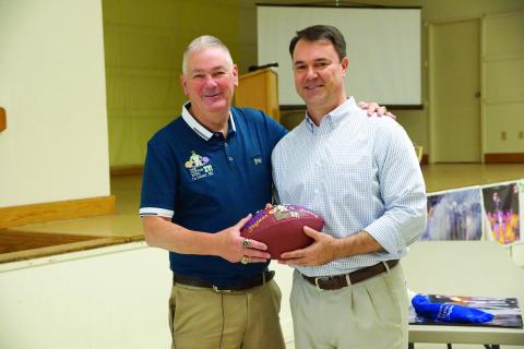 Man of the Year Tim Fontenot (left) is pictured as he gives a Tee Cotton Bowl game ball to LSU Baseball hero Warren Morris. (Gazette file photo)