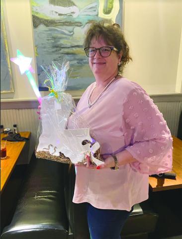Tonya Soileau, of Pine Prairie High School, shows off a gift for being recognized as a support employee of the year state finalist. (Photo courtesy of Grace Sibley)