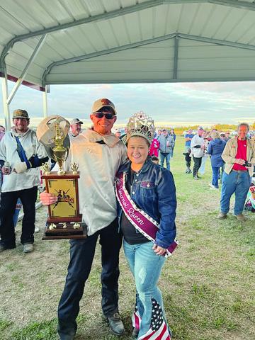 Tournoi champion Marcus Guillory (left) is presented his First  Place trophy by Tournoi Queen Shelbi Guidry. (Gazette photo by Tony Marks)