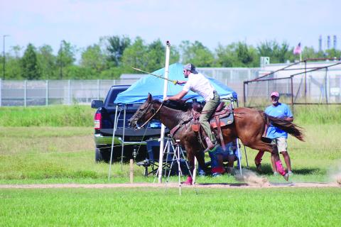 Eric Guillory is pictured as he collects one of the seven Tournoi rings that represent the seven enemies of cotton during the qualifications held Sunday, September 13. (Gazette photo by Tony Marks)