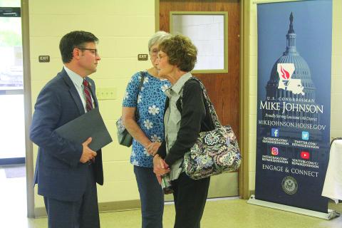 Congressman Mike Johnson visits with Linda Lebsack, member of the Evangeline Chamber of Commerce and library board.