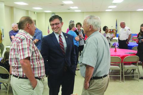 Congressman Mike Johnson (center), newly elected Speaker of the House of Representatives, shares a laugh with Joey West (left) and former School Board President Wayne Dardeau (right) during a town hall event held last year in Pine Prairie. (Gazette photo by Tony Marks)