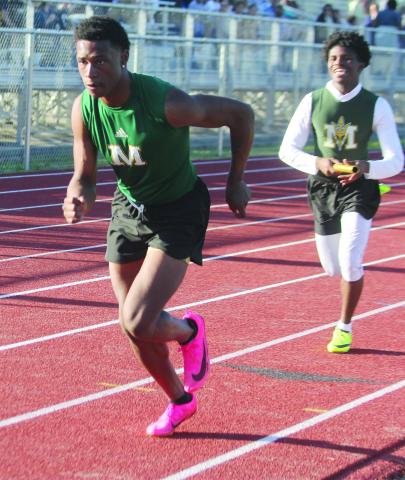 Mamou’s Keshawn Guillory (front) and Kevin Jason (back) participate in a relay race during the track meet held Tuesday, March 26, at Pine Prairie. (Gazette photo by Rhett Manuel)