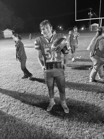 Gabe David, of the Basile Bearcats, is pictured with the Battle of Bayou Nezpique Trophy after beating Elton last Friday night. (Gazette photo by Tony Marks)
