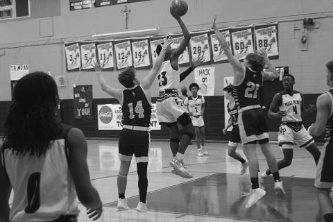 Ville Platte’s Sage Papillion (23) goes up for a basket while being defended by Sacred Heart’s Keegan McIntosh (14) and Austin Darbonne (21). (Gazette photo by Tony Marks)