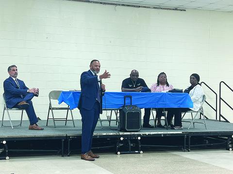 United States Attorney for the Western District of Louisiana Brandon Brown (standing) is pictured as he speaks to a gathering of law enforcement personnel and other community leaders at the Martin Luther King Center. Seated from left are Myers Namie with the US Attorney’s Office, Ville Platte Housing Authority Chair Arthur Sampson, Ville Platte Housing Authority Vice Chair Wanda Skinner, and Ville Platte Housing Authority Acting Executive Director Sheila Ben. (Gazette photo by Tony Marks)