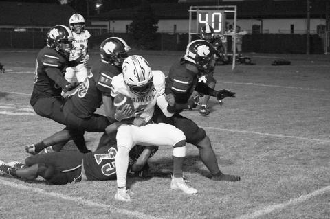 Members of the Ville Platte defensive team swarm to make a stop against a Crowley rusher in the Bulldogs’ 13-12 win on homecoming night to begin district play. (LSN photo by Chuck Sexton)
