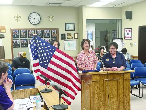 From left are Sarahi Sawtelle, Nina David, and Mable Foreman as they display a United States Flag at the Ville Platte City Council meeting held Tuesday, September 10. (Gazette photo by Tony Marks)