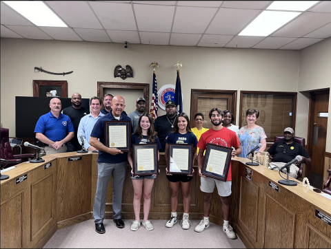 Pictured from left are: back row- City Councilmen Bryant Riggs and Tracey Jagneaux; middle row- Fire Chief Chris Soileau, City Clerk Donald Bergeron, City Councilman Shawn Roy, Mayor Ryan LeDay Williams, City Councilwomen Anna Frank, Christine Sam, and Faye Lemoine, and Police Chief Al Perry Thomas (seated); front row- Sacred Heart powerlifting coach Duane Urbina, and Sacred Heart powerlifters Madeline Fusilier, Adeline Launey, and Jesse Johnson. (Gazette photo by Nancy Duplechain)