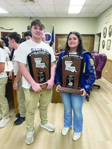 Sam LaFleur (left) and Haylee Dupre (right) are pictured as they display the state runner-up trophies in powerlifting. Both are senior captains for this year’s Sacred Heart teams. (Photo courtesy of Misty Parker)