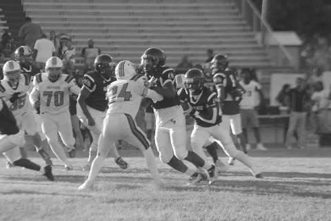 Darius Chagois (8) provides a block to allow Latelldrick Prejean (3) to pick up positive yardage for Ville Platte against Pine Prairie. (Gazette photo by Tony Marks)