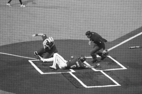Cade Arrambide (0) slides across home plate ahead of a tag from the Vanderbilt catcher in Game 1 of LSU’s conference opening series against the Commodores on Friday, March 13. (Gazette photo by Tony Marks)