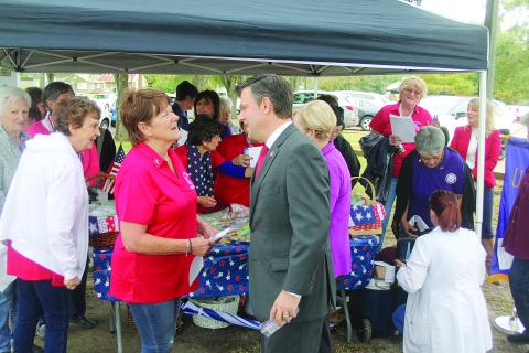 Congressman Mike Johnson (right) visits with local Catholic Daughters of America Regent Fannie Soileau outside the Evangeline Parish Courthouse on Thursday, November 11, for Veterans Day. (Gazette photo by Tony Marks)