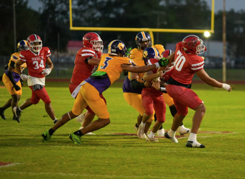Cameron Seriale (3) and other members of the Ville Platte defense combine for a stop against the Basile Bearcats last Friday night as the Bulldogs earned their second win of the season. (Photo by Tonya Ortego)