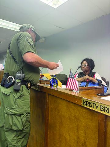 School Board member Wanda Skinner is pictured on the right as she is served with her court date, January 6, 2025, at 1 p.m. (Gazette photo by Tony Marks)