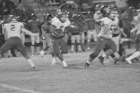 Bryan Hardy (5) looks to follow blocker Wyatt Bertrand (55) for a big gain in Basile’s playoff loss to Welsh. (Gazette photo by Rhett Manuel)