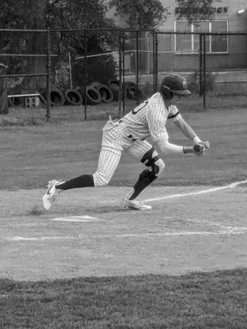 Landon LeBlanc (20) attempts to lay down a bunt. (Gazette photo by Rhett Manuel)