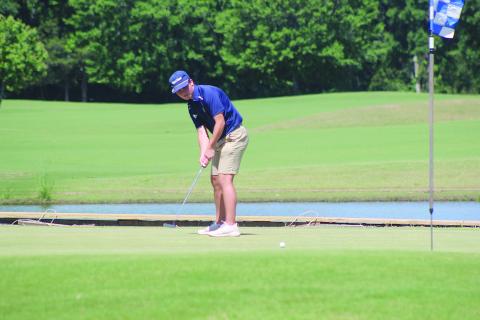William Chapman is pictured as he tries to make a putt during the first round of the state golf tournament on Monday, May 4, in Carencro. (Gazette photo by Tony Marks)