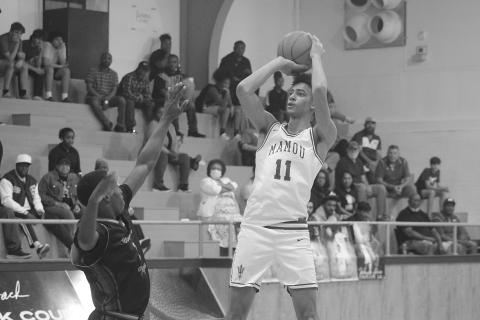 Braxton Ardoin (11) scores a goal for Mamou in its playoff-opening win against Winnfield. He led the Green Demons with 28 points in their 68-50 win. (Gazette photo by Tony Marks)