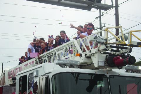 (Left photo) The Ville Platte 8U Elite All-Stars claimed the championship at the PONY World Series, which was played in Buda, Texas. Team members and coaches are pictured as they ride in a championship parade on Tuesday, July 14. Head coach is Sam Miller; and players are Aimee Fontenot, Alyssa Blood, Ava Fontenot, Eleanor Fontenot, Emma Kate Fontenot, Jolie Ludeau, Journey Broussard, Landry Leger, Lyla Miller, Nora Delafosse, Remi Veillon, and Ro’Miyah Hill. (Gazette photo by Tony Marks)