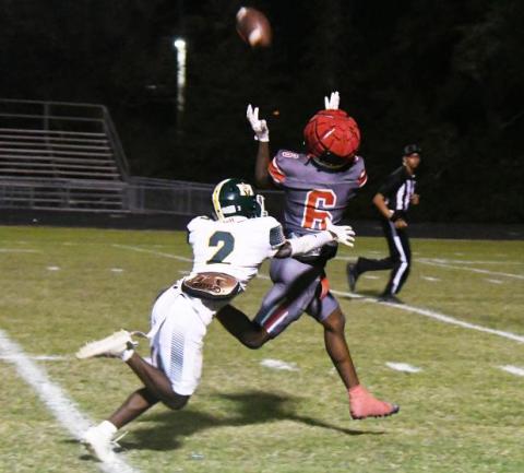 Kevin Jason (2) attempts to make a tackle on Abbeville’s Jacolby Campbell (6). (Photo courtesy of The Abbeville Meridional)