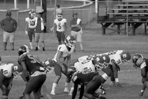 (At left) Bearcat quarterback Luc Johnson (4) lines up behind his center Christian Bergeron (73) in a game against Ville Platte earlier this season. Other identifiable Bearcats visible on the line are (from left) Emory LeJeune (65), Wyatt Bertrand (55), and Da’Shawn Randell (78). (Photo by Nikki Johnson)