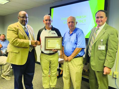 PPHS RECEIVES ASVAB AWARD - Pine Prairie High School received a platinum rating from ASVAB for the school’s 15 years of participation in and support of the ASVAB Career Exploration Program. Shown, from left, are Superintendent Darwan Lazard, Principal Toby Doucet, School Board President Wayne Dardeau and Assistant Superintendent Mike Lombas. (Gazette photo by Heather Bogard)