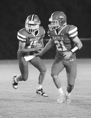 Bearcat quarterback Ricky Malone (15) follows the block of teammate Kye Smith (21) during Basile’s Homecoming game against the Ville Platte Bulldogs. (Photo by Tonya Ortego)