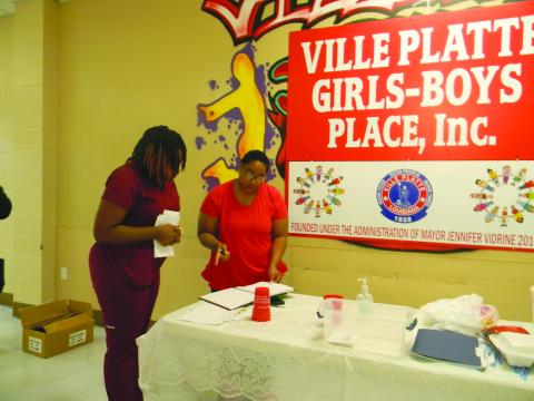 HEAD START SERVICES AVAILABLE - Sharron Gilbeaux, family service coordinator with Save the Children Head Start (right), assists a parent with registering her child for the 2022-20223 program year during the recruitment event held Wednesday, June 29, at the Girls and Boys Place in Ville Platte. (Gazette photo by Heather Bogard)