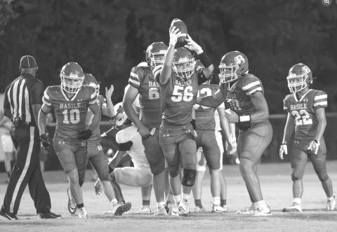 INTERCEPTION - Basile’s William Ashford (56) and several of his teammates celebrate an interception during a recent Bearcat game. Other BHS players pictured  are Carter Darbonne (10), Jack Comeaux (66), Zachary Mason (70), and Logan Bergeron (22). (Photo by Lanie LeJeune)