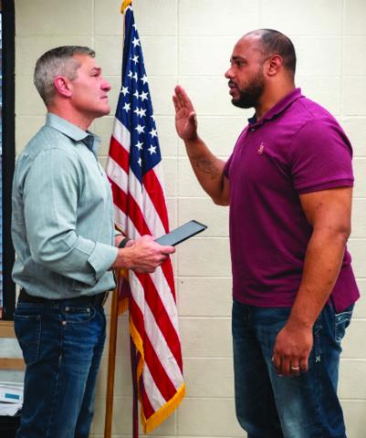 INTERIM POLICE CHIEF TAKES OATH - Nicholas Richardson (right) takes the oath of office for the position of interim police chief for the Town of Basile. Dave Johnson, town attorney and magistrate judge, is shown administering the oath following the Feb. 18 special meeting of the mayor and council. (LSN photo by Darrel LeJeune)
