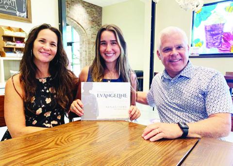 Holding the book “A Modern Retelling of Evangeline” is Lucy Simon (middle), who sang six of the 19 songs. Also in the photo are Lucy’s mom, Michelle, and Jared Bourque, the father of Fr. John Joseph Bourque.