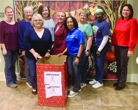 EVANGELINE PARISH LIBRARIES SUPPORTING CASA TOY DRIVE - (left to right) Angie Henry of the Pine Prairie branch, Ruth Stanley and Gigi Fontenot of the Mamou branch; Sherry Bergeron, Basile branch; Amy King, Turkey Creek branch; Keisha Ford, Jane Vidrine, and Patricia Harris, all of the main library in Ville Platte, and Rebecca Leger, Basile branch.