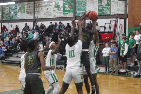 Mamou’s Tyrian Broussard (10) fights for a bucket in the Green Demons’ loss to Eunice, 72-59. (Gazette photo by Rhett Manuel)