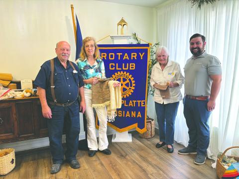 PASSION FOR COTTON SHARED - Belinda Berzas and Mavis Fruge shared their passion for cotton weaving and spinning to make various items. Shown from left, are Rotarian Bob Manuel, Belinda Berzas, Mavis Fruge and Rotary President Beau Wilson. (Gazette photo by Heather Bogard)