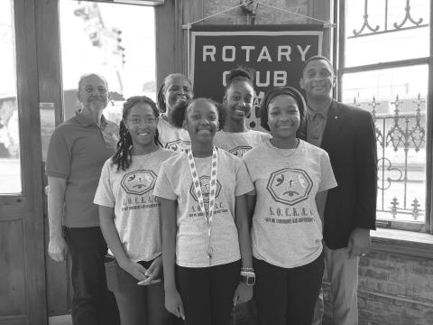 HEALTH COACH SHARES TIPS -  Shown, in front, from left, are Gustavia “Mozie” Sanchez, Nylah “Lex” Guillory and Ariena “Yoni” Boast. In the back row, same order, are guest speaker Neil Ortego, Rotarian Linda Fontenot, Zaleria “Z” Calvin and Rotary President Brian Ardoin. The students are participants in the Save Our Community Kids Adventure Camp. (Gazette photo by Heather Bogard)