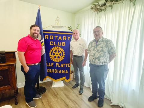 LELEUX SHARES JOY OF OFFICIATING - Keith LeLeux, center, addressed the July 7, meeting of the Ville Platte Rotary Club. He is shown with Rotary President Beau Wilson (left) and Rotarian Dan Poret (right). (Gazette photo by Heather Bogard)