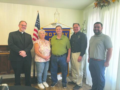 HISTORY OF VILLE PLATTE ROTARY CLUB SHARED - Shown, from left, are honorary Rotarians Father Mitchell Guidry, Darlene Bolfa and Ray Duplechain, Rotarian Wayne Vidrine and Rotary President Beau Wilson. Vidrine shared a brief history of the club during the August 26 meeting. (Gazette photo by Heather Bogard)